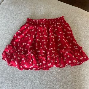 Alice Elle red skirt with daisy print.